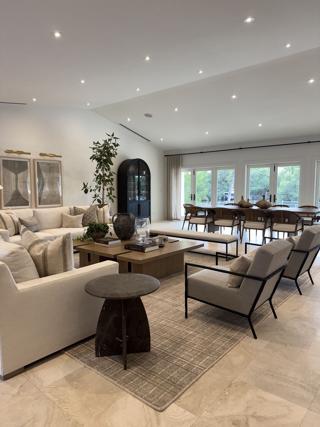 Open living room with cream sectional, oak coffee table, and marble side table