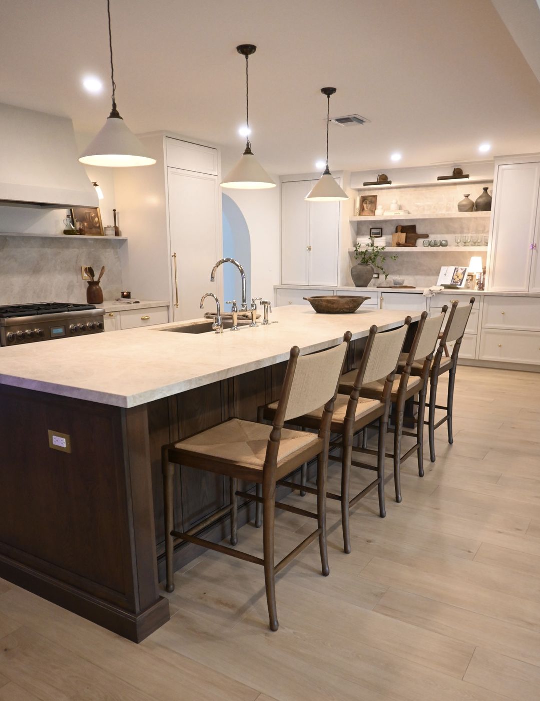 Kitchen with range, plaster hood, and open shelving